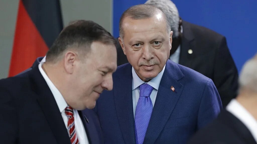 Turkish President Recep Tayyip Erdogan (C) looks on as then-US Secretary of State Mike Pompeo (L) walks past prior a family picture during a Peace summit on Libya at the Chancellery in Berlin, on January 19, 2020.  (AFP)