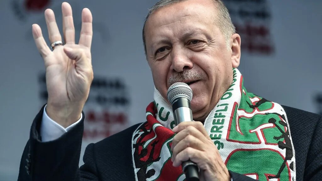 Turkish President Recep Tayyip Erdogan flashes four finger and makes the Rabia sign as he speaks during a pre-election rally at Bayrampasa district in Istanbul, on March 30, 2019. (AFP)