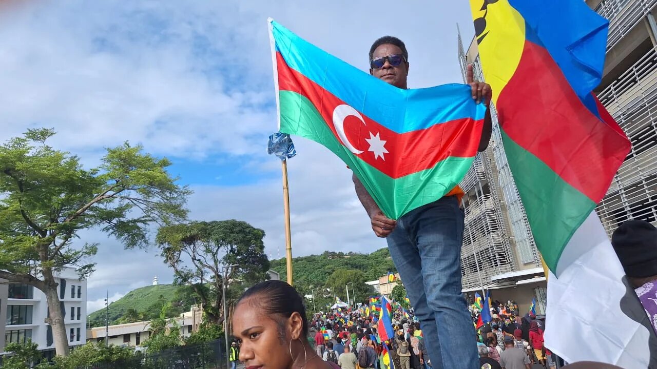 Protestors hold the flags of Azerbaijan and New Caledonia in this picture shared on X, formerly known as Twitter, in 29 March 2024 (Screenshot)