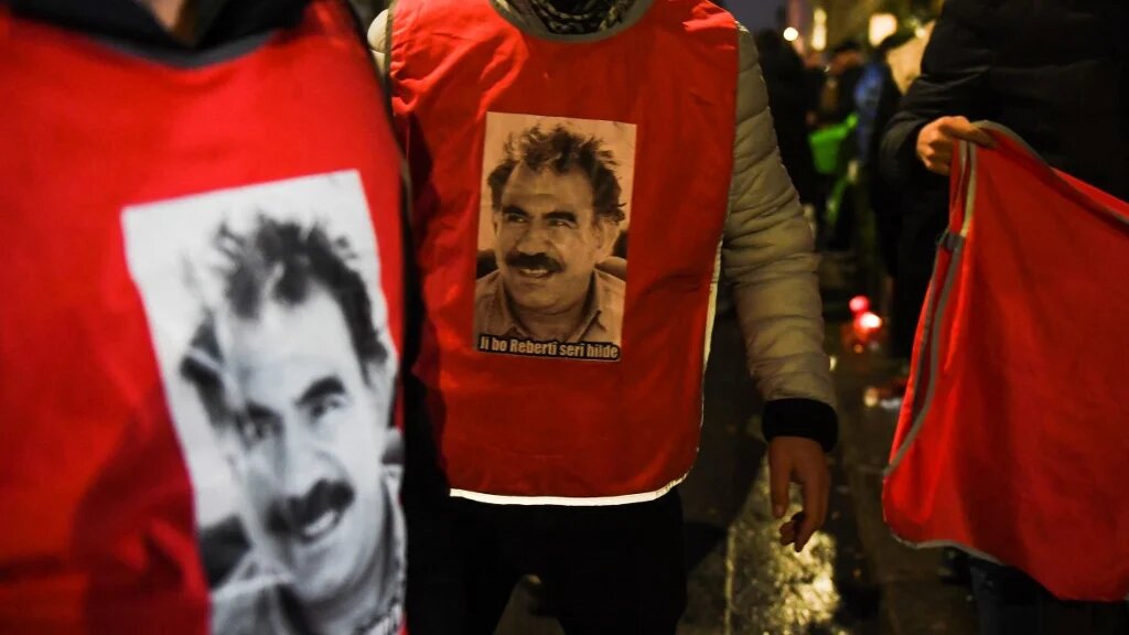 Participants wearing jerseys with the face of Abdullah Ocalan, leader of the Kurdistan Worker's Party (PKK), gather in Paris, on December 24, 2022.  (Julie SEBADELHA /AFP)