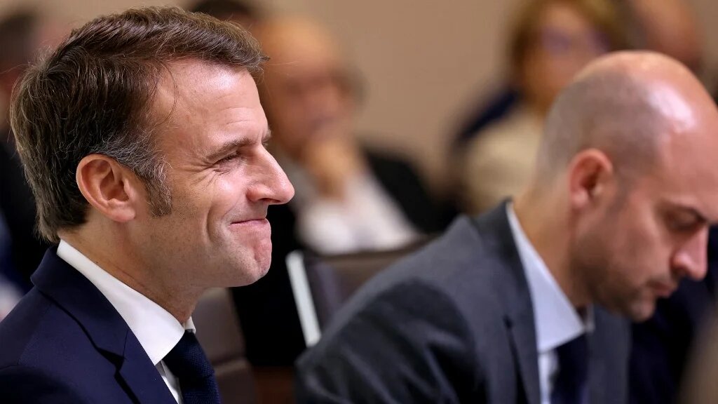 France's President Emmanuel Macron (left) reacts next to French Foreign Affairs Minister Jean-Noel Barrot during an international press conference in support of Lebanon, in Paris on 24 October (Alain Jocard/POOL/AFP)