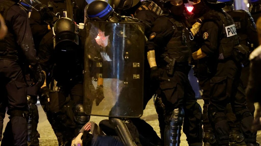 French police officers detain a demonstrator in Paris on 2 July 2023, five days after 17-year-old Nahel Merzouk was killed by police in Nanterre, a suburb of Paris (AFP)