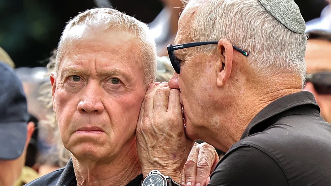 Israeli opposition lawmaker Benny Gantz (R) speaks to former Israeli defence minister Yoav Gallant, June 2025 (AFP)