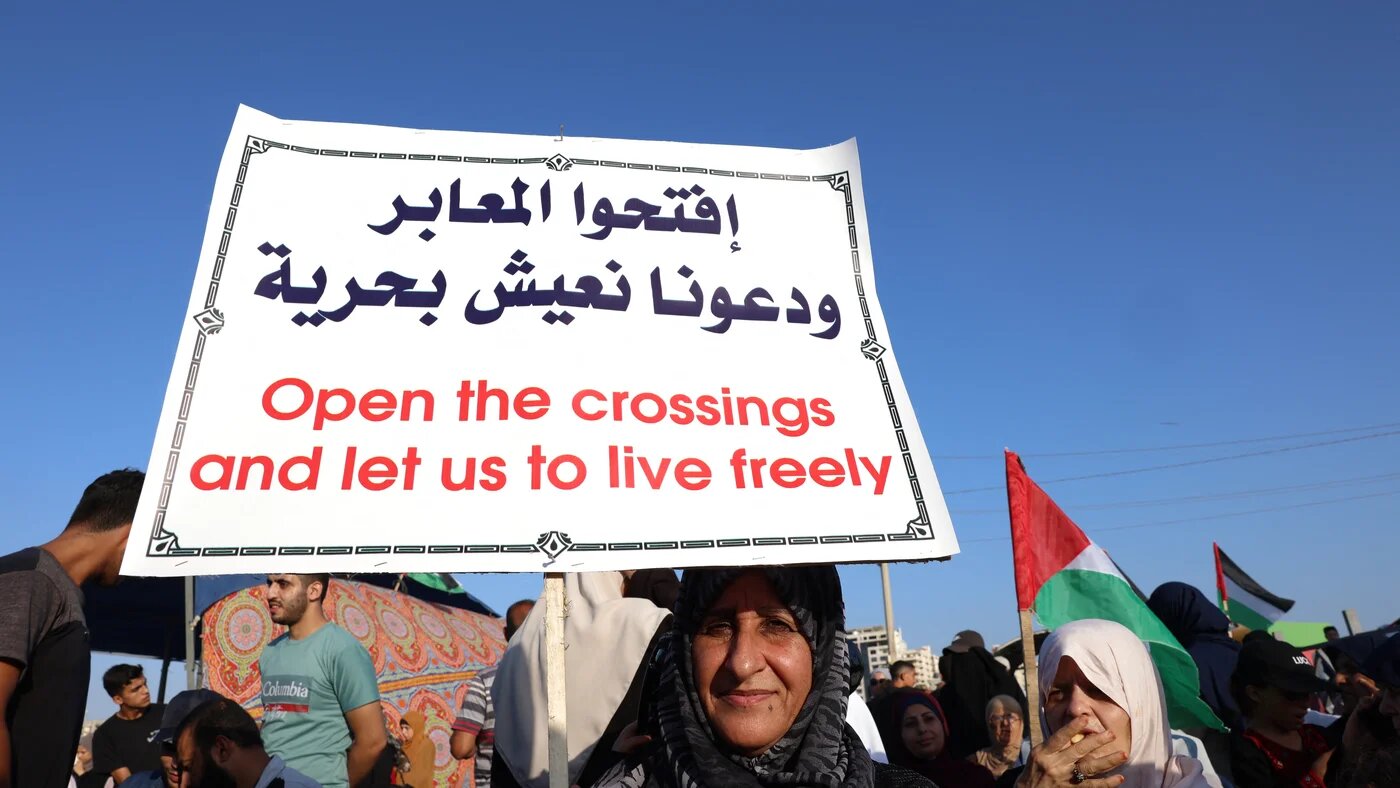 Palestinians participate in a rally at the Gaza City sea port demanding the lifting of the 15-year Israeli blockade on 13 September 2022 (AFP)