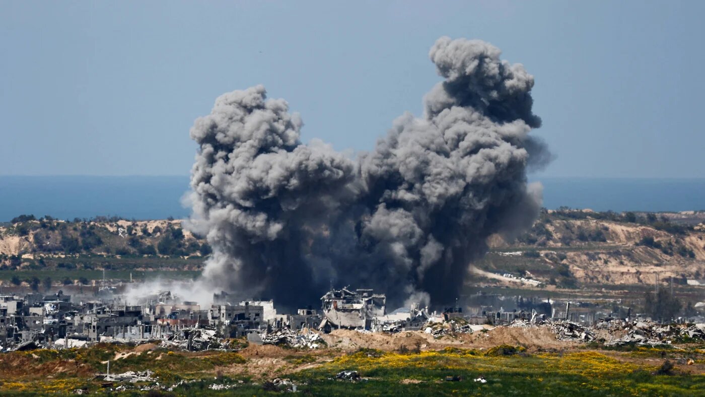 Smoke rises from Gaza during an explosion following an air strike on 23 March 2024 (Reuters)