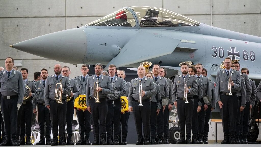 German soldiers take part in a ceremony in front of an Eurofighter jet on 26 February (Lukas Barth-Tuttas/AFP)