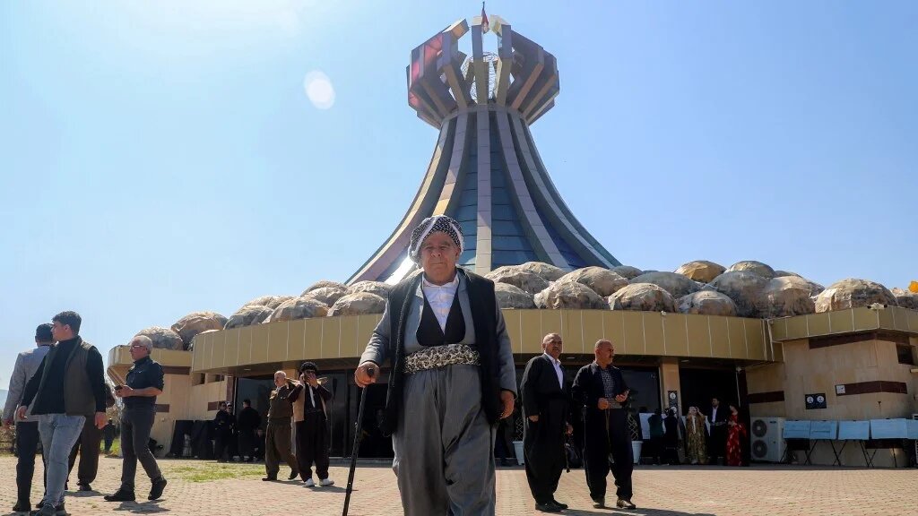 People walk outside the memorial to the 1988 Halabja chemical attack on 16 March (Shwan Mohammed/AFP)