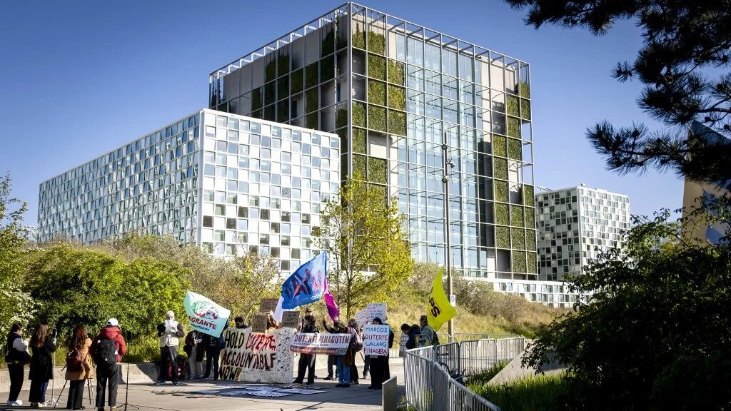 Protesters hold placards in front of the International Criminal Court (ICC) ahead of the ruling on the appeal by former Philippines President Rodrigo Duterte in The Hague on 22 April (AFP)