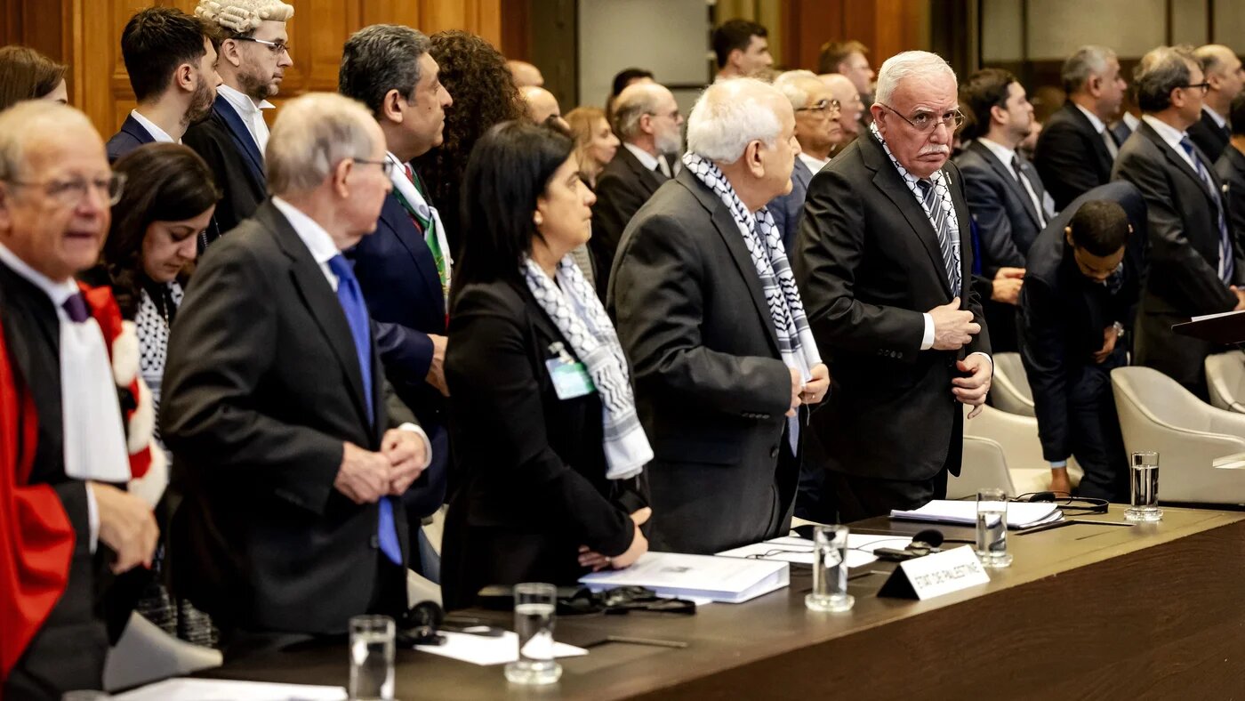 Minister of Foreign Affairs of the Palestinian Authority Riyad al-Maliki (R) stands with colleagues at the start of a hearing at the International Court of Justice (ICJ) on the legal consequences of the Israeli occupation of Palestinian territories, in The Hague on 19 February 2024 (Robin van Lonkhuijsen/ANP/AFP)
