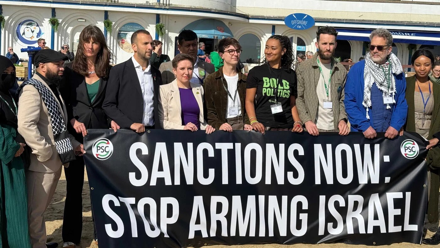 Green Party Leader Zack Polanski and other key party figures, including the co-deputy leaders, stand on the beach in Bournemouth during the party's conference to demand sanctions on Israel. (International Centre of Justice for Palestinians)