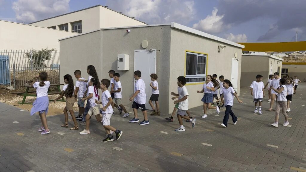 Children displaced from the northern border with Lebanon arrive for the first day of school at the Ramat Korazim elementary school near Elifelet in northern Israel on September 1 2024 (Menahem Kahana / AFP)