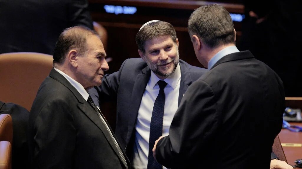 Israel's Finance Minister Bezalel Smotrich (C) stands at the Israeli parliament, the Knesset, ahead of an address by the US president in Jerusalem on October 13, 2025 (Chip Somodevilla / POOL / AFP)