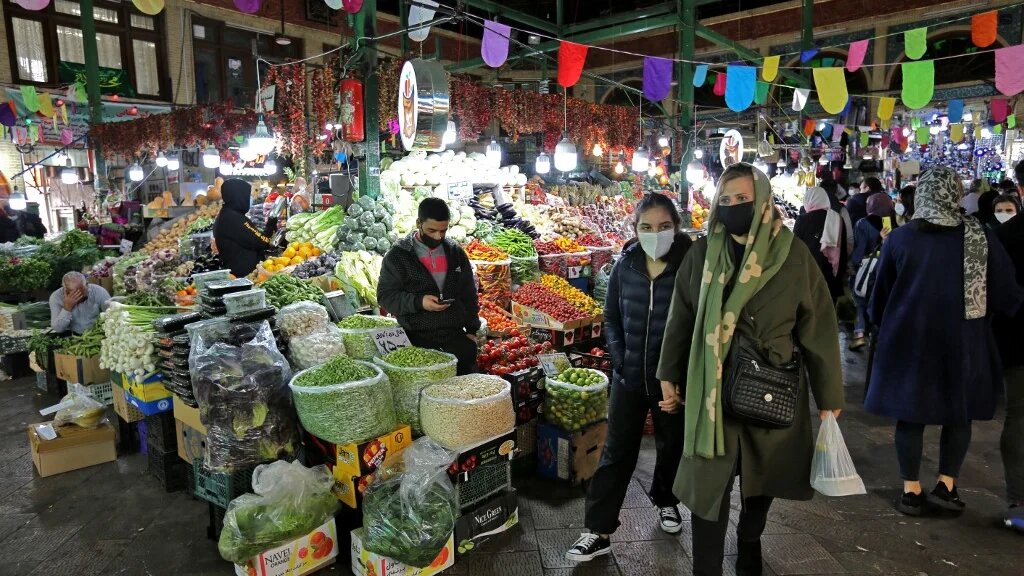 Mask-clad Iranians shop amid the Covid-19 pandemic, at the Tajrish Bazaar in Tehran on 17 March
