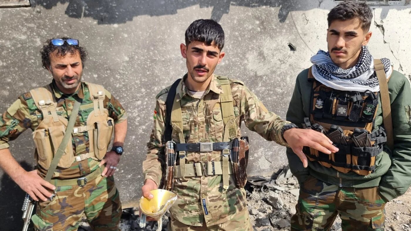 Iranian Kurdish fighters of the Khabat Organisation of Iranian Kurdistan Struggle show the aftermath of a drone attack on their base, March 13, Erbil province (Wladimir van Wilgenburg/MEE)