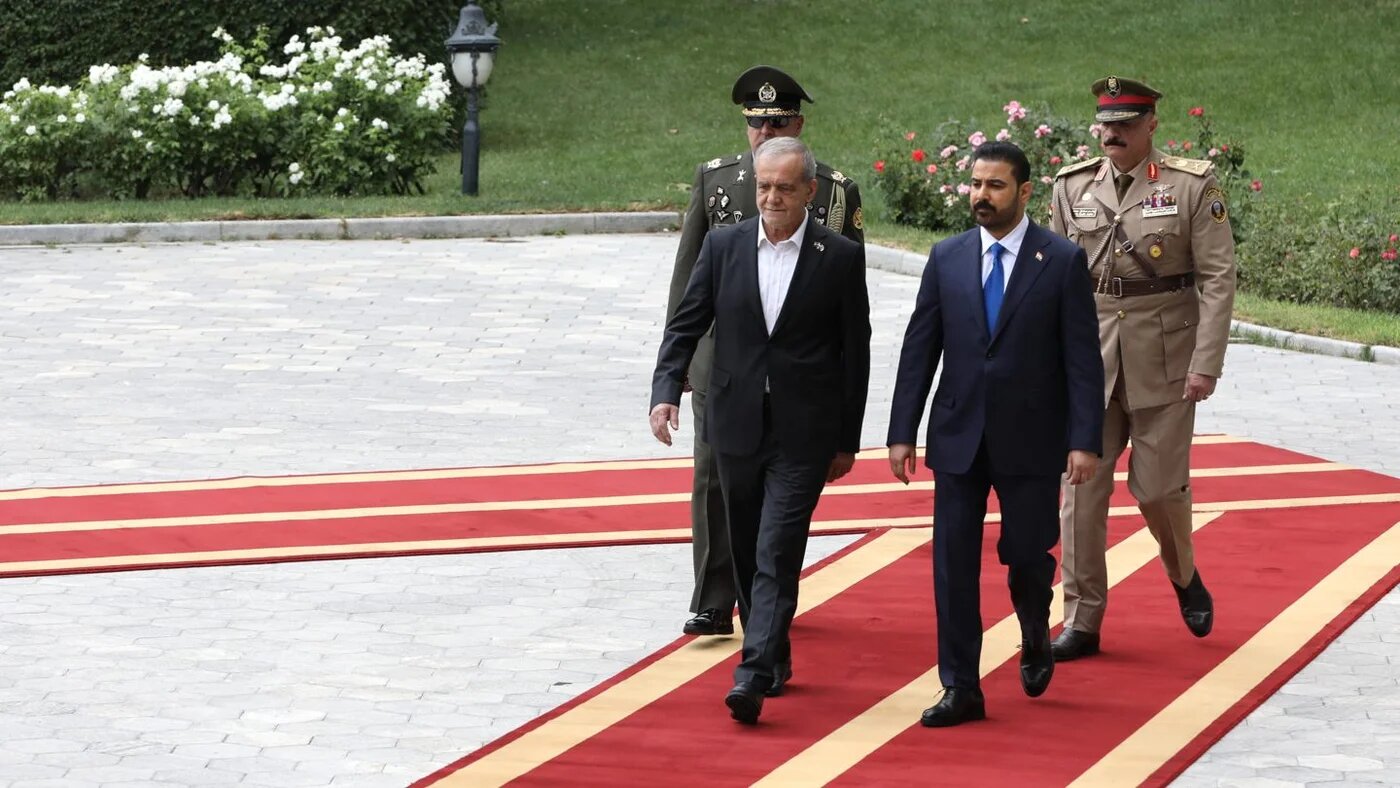 Iranian President Masoud Pezeshkian walks alongside Iraqi Prime Minister Ali al-Zaidi during a welcoming ceremony in Tehran, 23 July 2026 (Iranian Presidency/AFP)