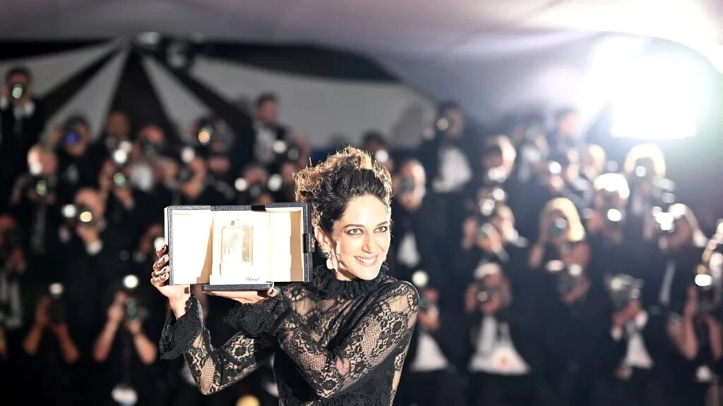 Iranian actress Zar Amir Ebrahimi poses with her best actress trophy during the closing ceremony of the 75th edition of the Cannes Film Festival in southern France, 28 May 2022 (AFP)