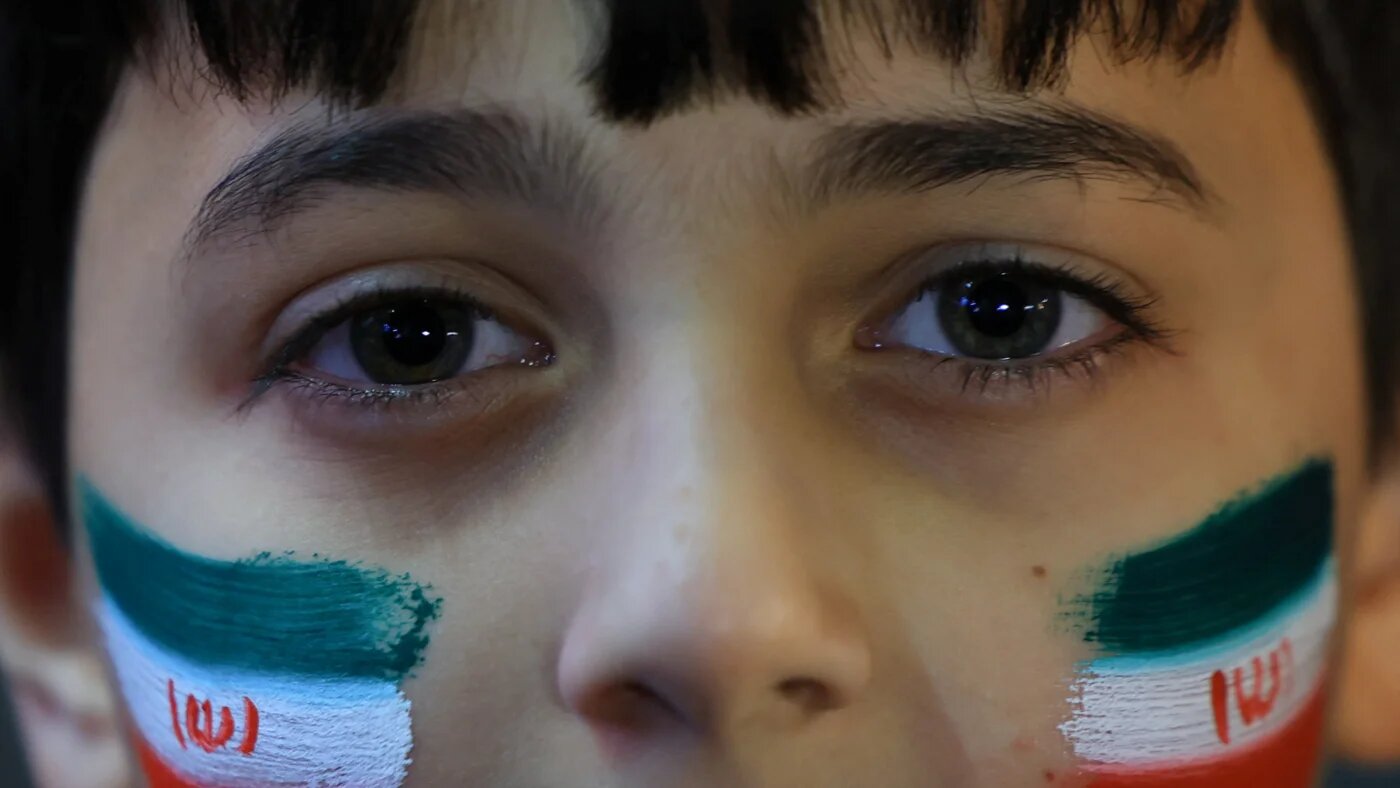 A boy looks on during an anti-U.S. and anti-Israel rally at Enghelab Square amid a ceasefire between U.S. and Iran, in Tehran, Iran, April 15, 2026. REUTERS/Thaier Al-Sudani 