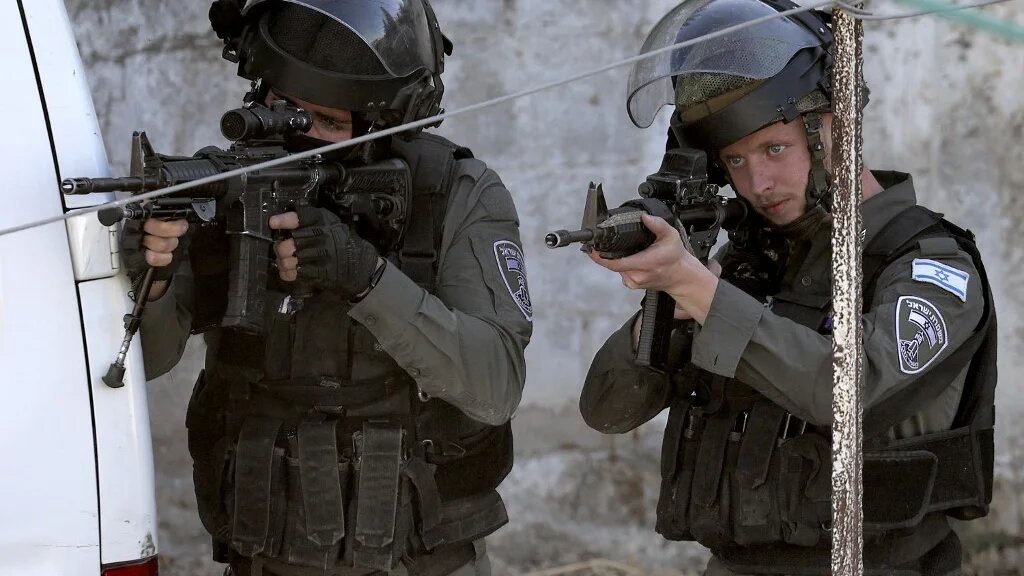 Israeli border guards raid a house in Rummanah, in the occupied West Bank, reportedly the home of a Palestinian man suspected of carrying out a fatal axe attack in the central city of Elad two days earlier (AFP)