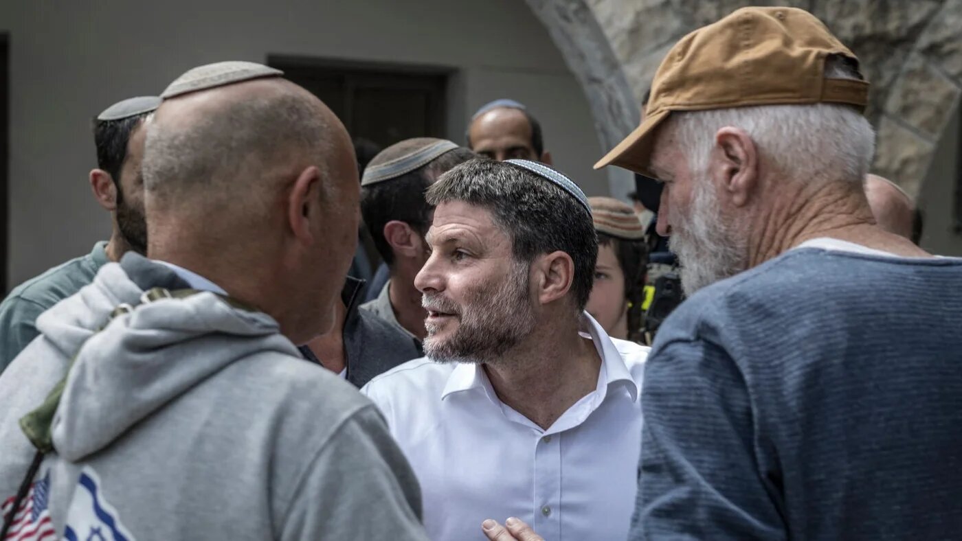 Israel’s Finance Minister Bezalel Smotrich is surrounded by Israeli settlers during a settlement ceremony of Sa-Nur, in the occupied West Bank, 19 April 2026 (Marco Longari/AFP)