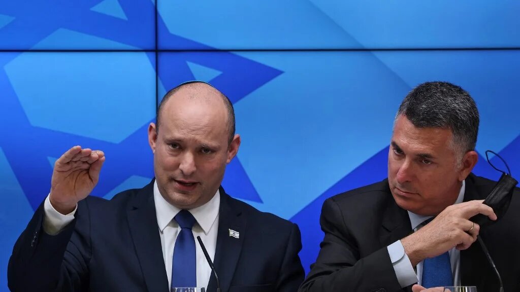 Israeli Prime Minister Naftali Bennett (L) speaks during a press conference on the economy in Jerusalem, on 6 July 2021, flanked by Justice Minister Gideon Saar (AFP)