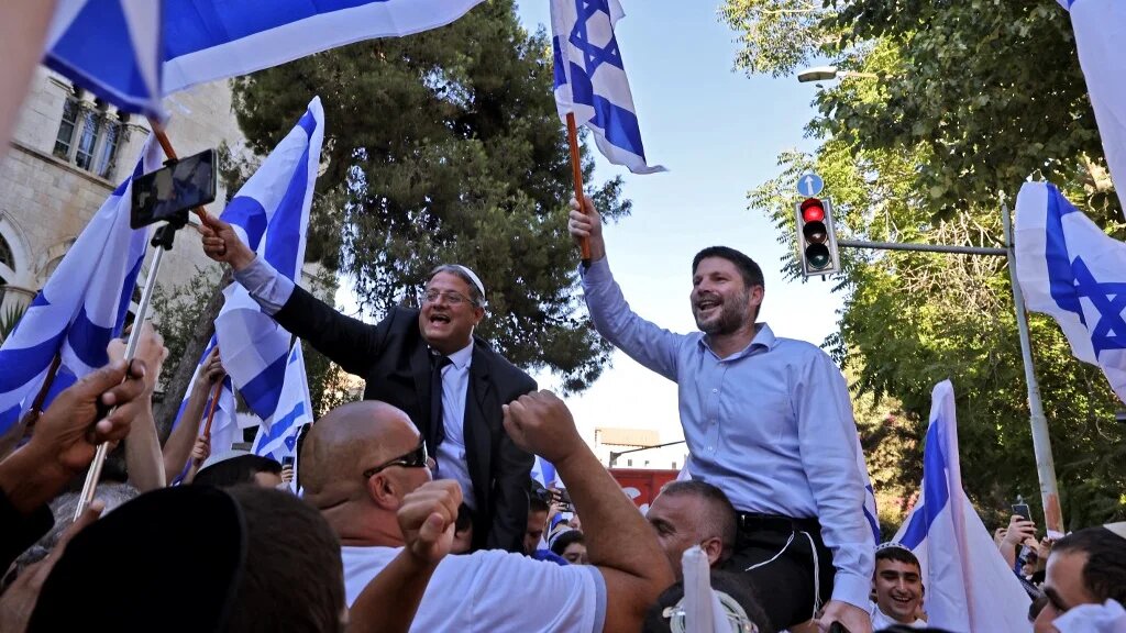 Israeli far-right lawmakers Bezalel Smotrich (R) and Itamar Ben-Gvir take part in the ultranationalist March of the Flags near Jerusalem's Old City, on June 15, 2021