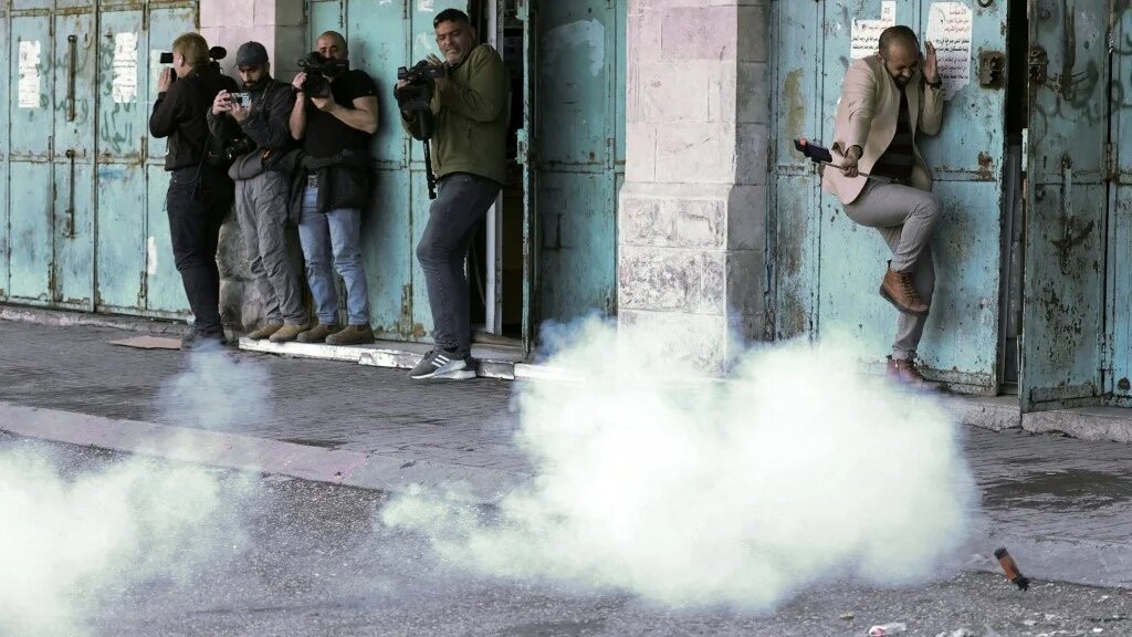 Israeli forces fired rubber-coated bullets at journalists covering confrontations in Hebron on 1 March 2022 (AFP)