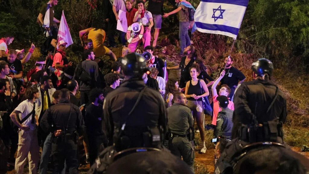 Israeli police surround protesters during a demonstration against the government's judicial reform bill, in Tel Aviv on 15 April 2023 (AFP)