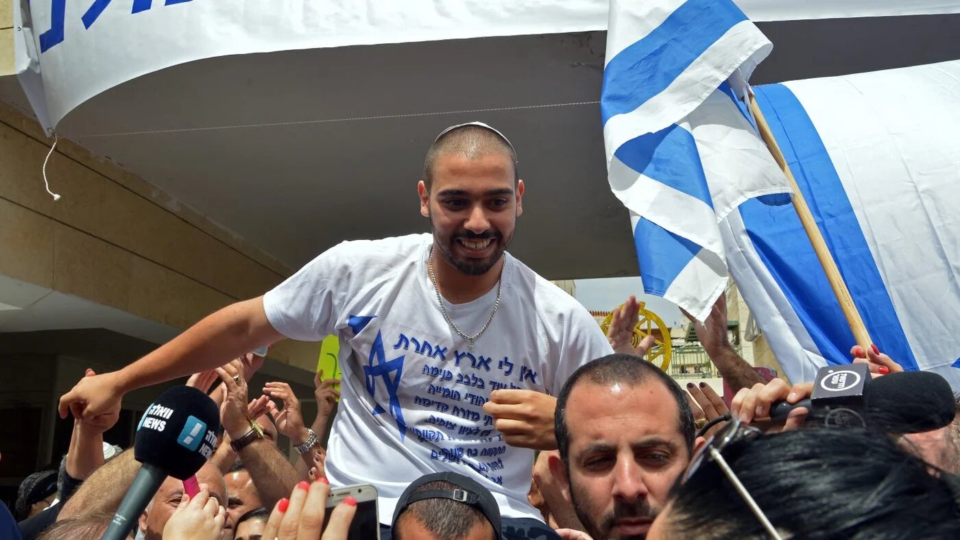 Israeli soldier Elor Azaria is lifted by friends near his family home in Ramla, near Tel Aviv, as they celebrate his release from prison, 8 May 2018 (AFP)