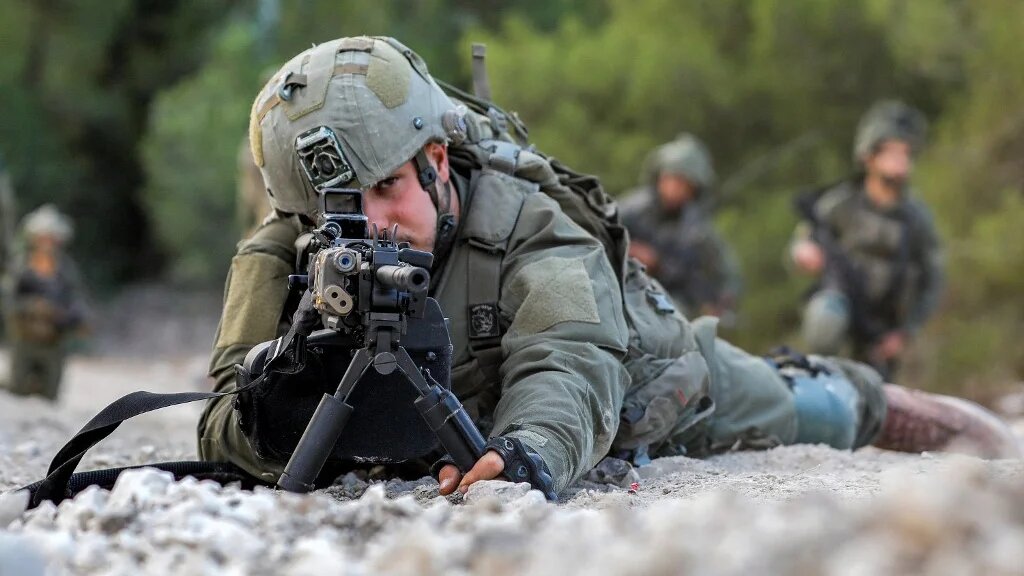 An Israeli army soldier in northern Israel near the border with Lebanon earlier this week (AFP)