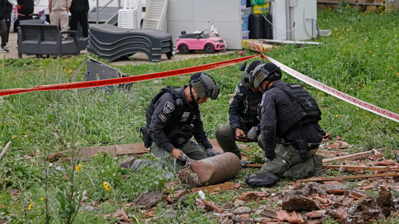 Israeli security forces gather at the site of a Hezbollah missile strike that targeted a house in the northern Israeli town of Kiryat Shmona near the border with Lebanon on 1 April 2026 (AFP)