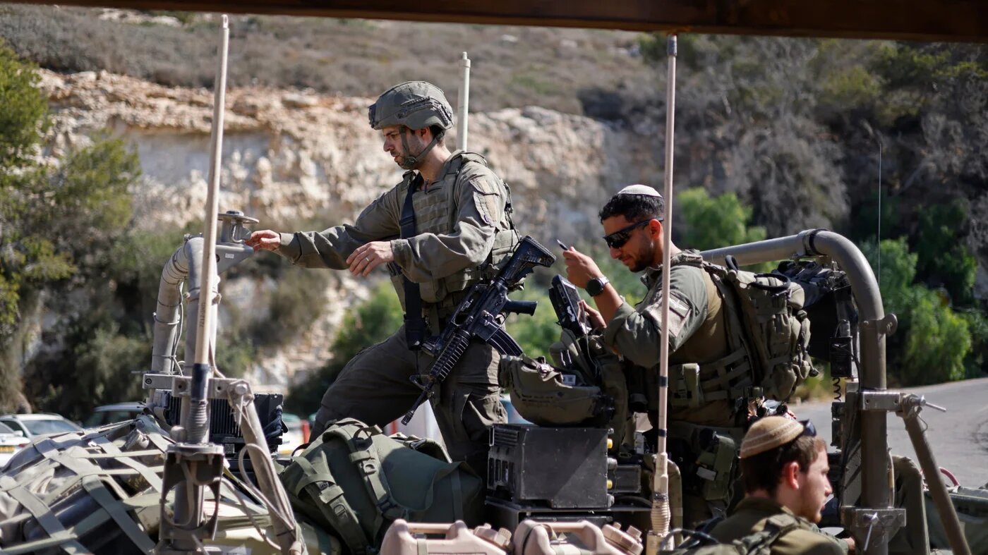 Israeli troops take a break as they prepare to enter south Lebanon, in Rosh HaNikra, northern Israel, on 4 September 2026 (AFP)