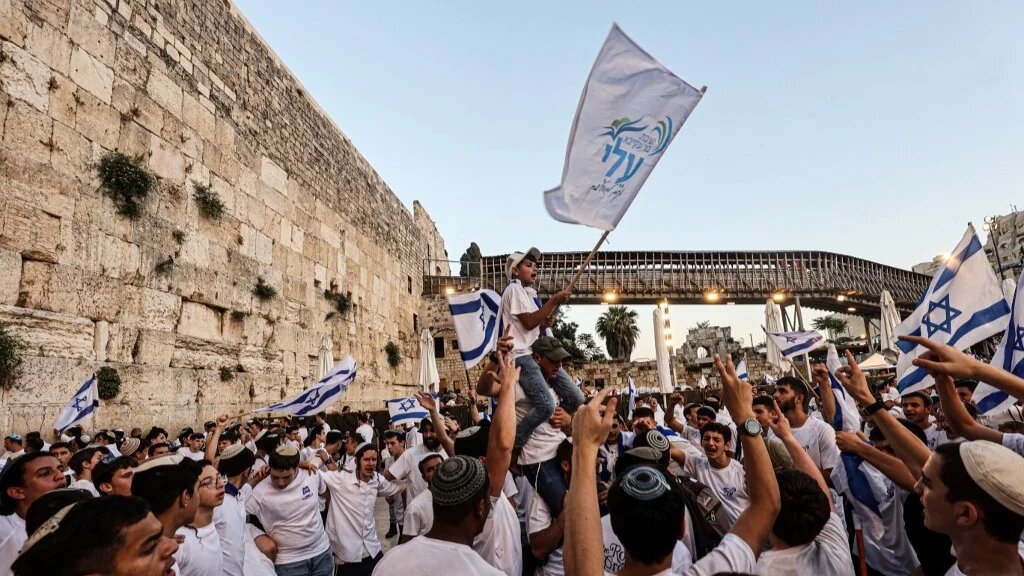 Israeli nationalists, including far-right activists, shout and dance at the Western Wall in the Old City of Jerusalem on 5 June 2024 during the so-called Jerusalem Day flag march (Gil Cohen-Magen/AFP)