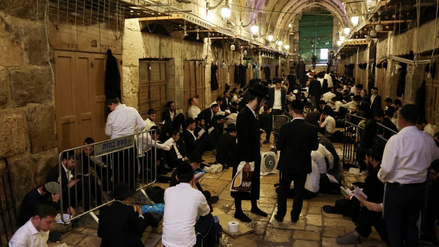 Jewish visitors pray at an entrance to the Al-Aqsa Mosque compound during Tisha B’Av in Jerusalem’s Old City, 23 July 2026 (Ammar Awad/Reuters)