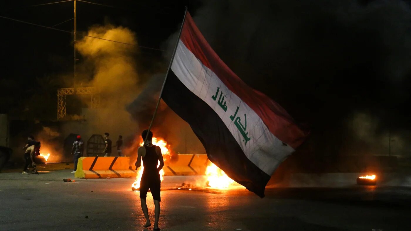 Iraqi protesters burn tyres in front of the Karbala governorate headquarters on Sunday 