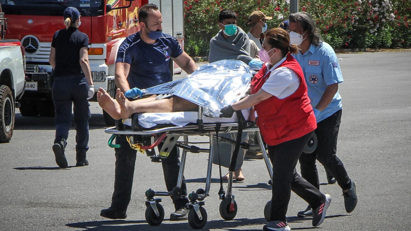 Medics carry a survivor on a stretcher at the port in Kalamata town, Greece, 14 June 2023 (AFP)