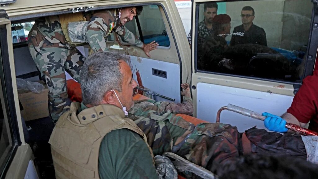 A wounded man is taken to hospital following strikes by Iran on the village of Altun Kupri, in Iraq's Kurdistan region, on 28 September 2022 (AFP)
