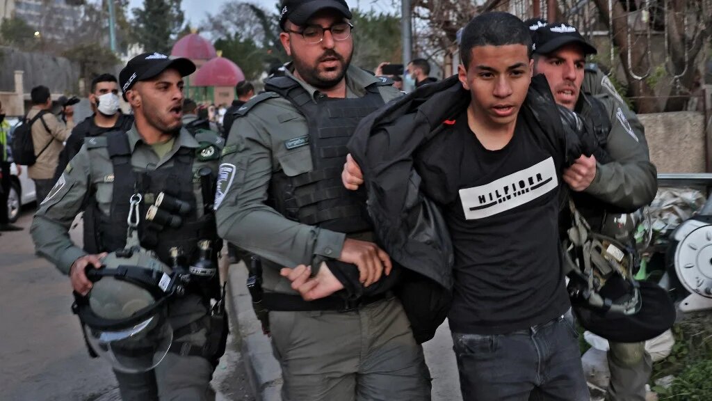 Israeli security forces detain a demonstrator during a protest in the flashpoint neighbourhood of Sheikh Jarrah in Israeli-annexed East Jerusalem, 18 February 2022 (AFP)