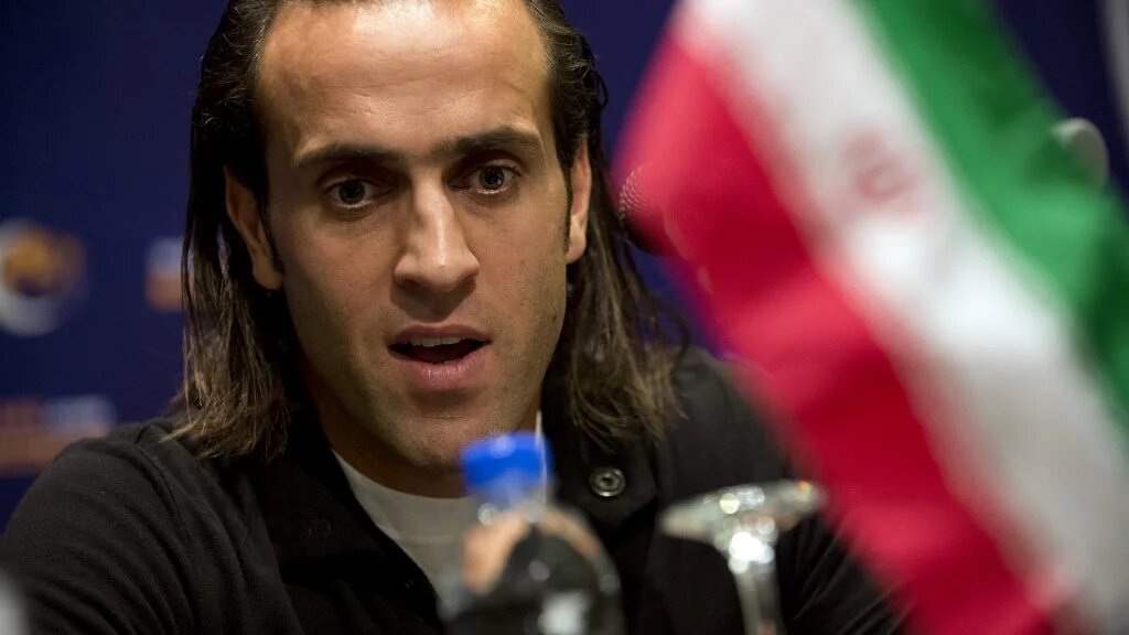Former Iranian midfielder Ali Karimi speaks at a press conference in Kuala Lumpur on 28 November 2012 (AFP)