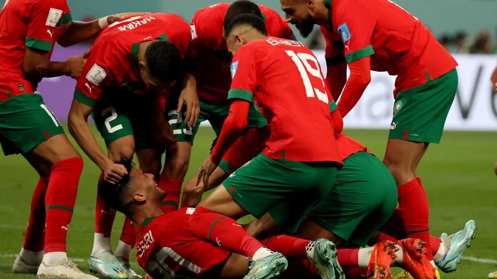 Morocco's Achraf Dari (C) is mobbed by his teammates after scoring in the third place play-off match against Croatia at Khalifa International Stadium, Doha on 17 December 2022 (AFP)