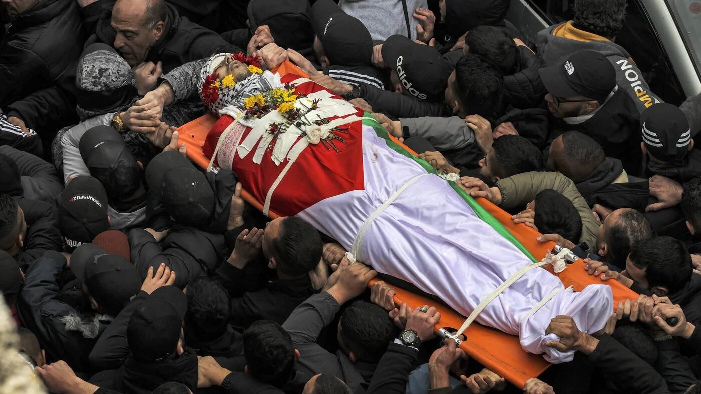 Mourners carry the body of Palestinian Alaa Shaham during his funeral at the Qalandia camp for Palestinian refugees south of Ramallah in the occupied West Bank on March 15, 2022