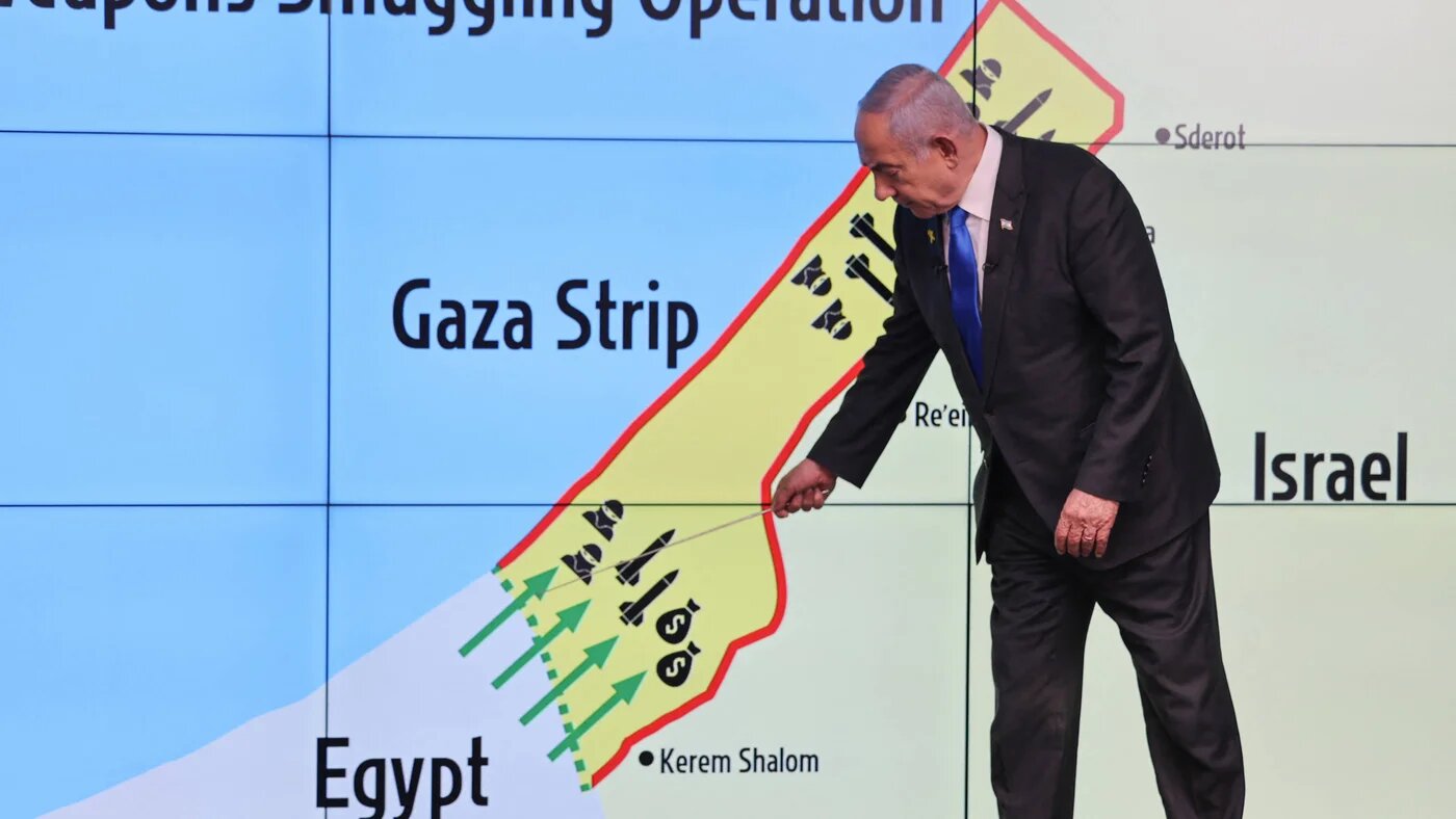 Israel's Prime Minister Benjamin Netanyahu points at the Philadelphi Corridor on a map during a press conference at the Government Press Office in Jerusalem on 4 September 2024 (AFP)