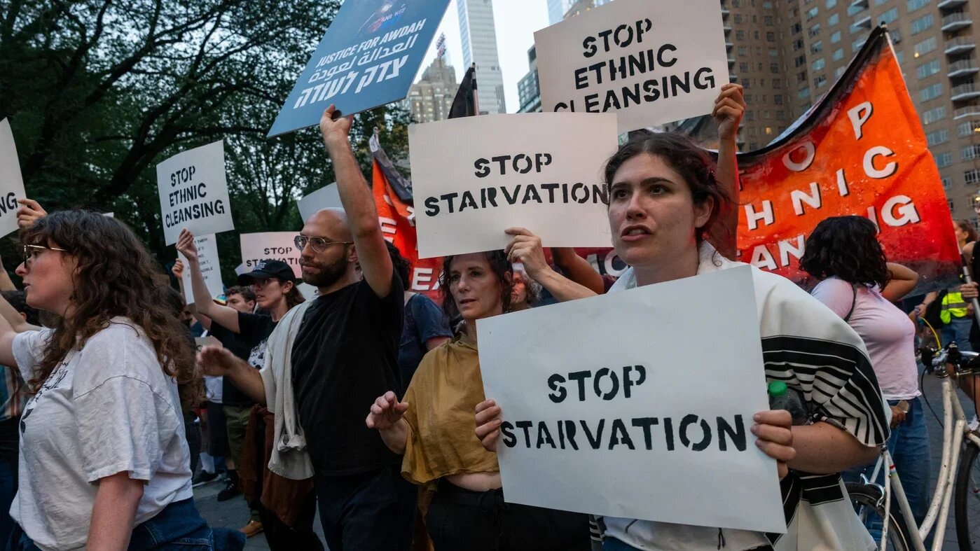Protesters demonstrating against the war in Gaza carry 'Stop Starvation' signs in New York City on 4 August (Spencer Platt/AFP)