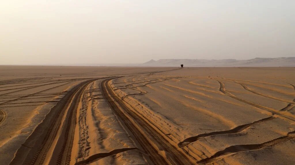 Trails left by trucks carrying food for humans and animals crossing the Sahara Desert are seen in the Djado area of Niger, on 22 May 2023 (Souleymane Ag Anara/AFP)