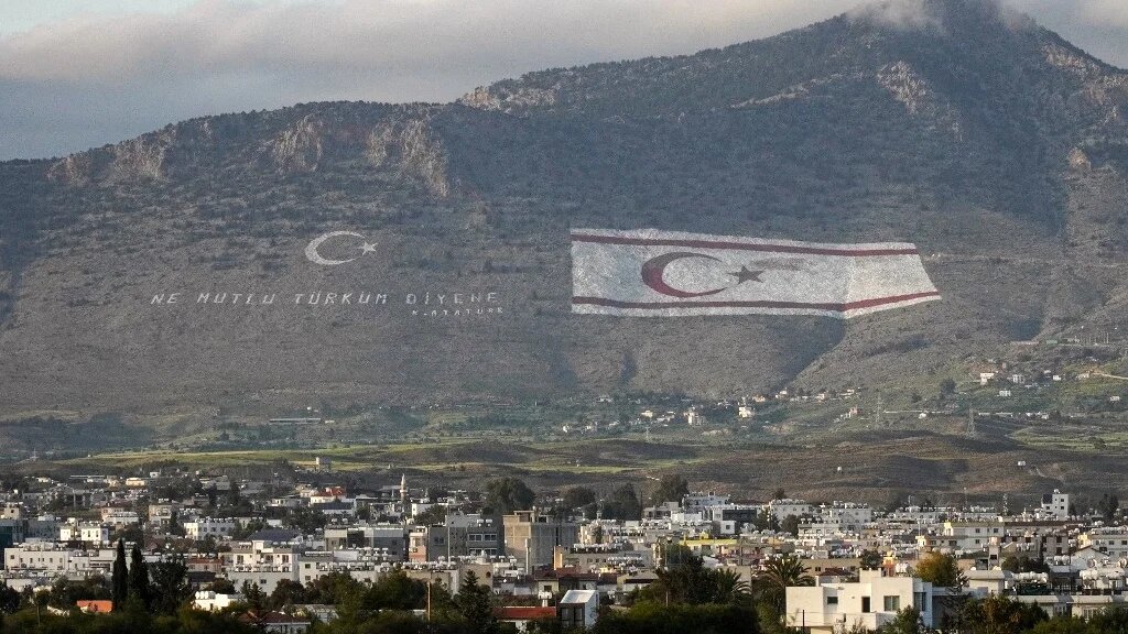 The Kyrenia mountain range north of the divided Cypriot capital, with the flags of Turkey and the Turkish Republic of Northern Cyprus (TRNC) painted on the mountain overlooking Nicosia (Roy ISSA/AFP)
