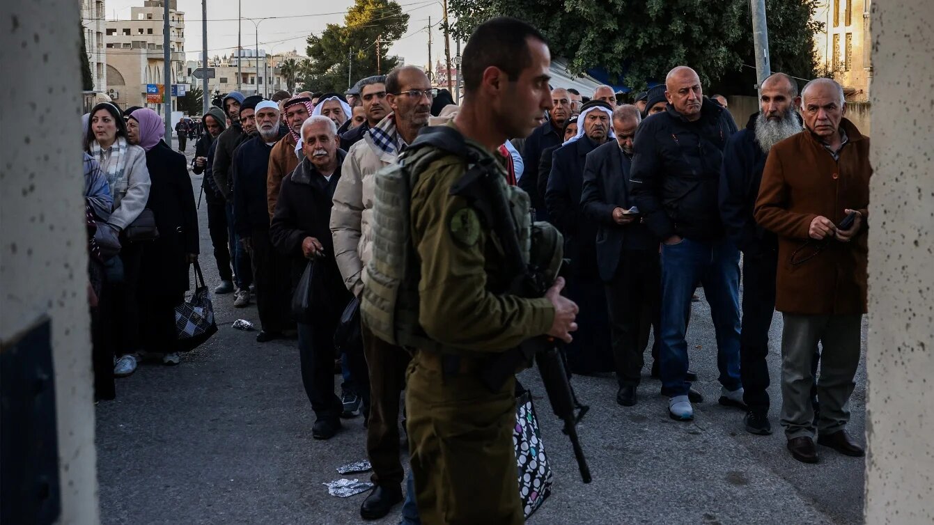 Palestinian Muslims gather at a checkpoint in the occupied West Bank city of Bethlehem on 20 February 2026, to enter Jerusalem on their way to Al-Aqsa Mosque. HAZEM BADER / AFP