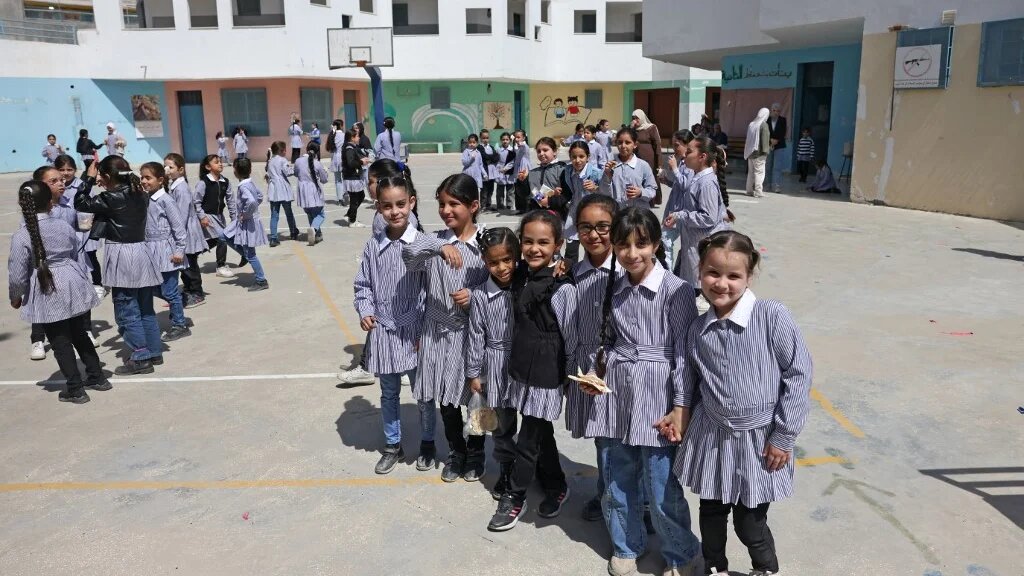 Palestinian schoolgirls in the playground of an Unrwa school in the Shuafat refugee camp in East Jerusalem, on 6 May (Ahmad Gharabli/AFP)