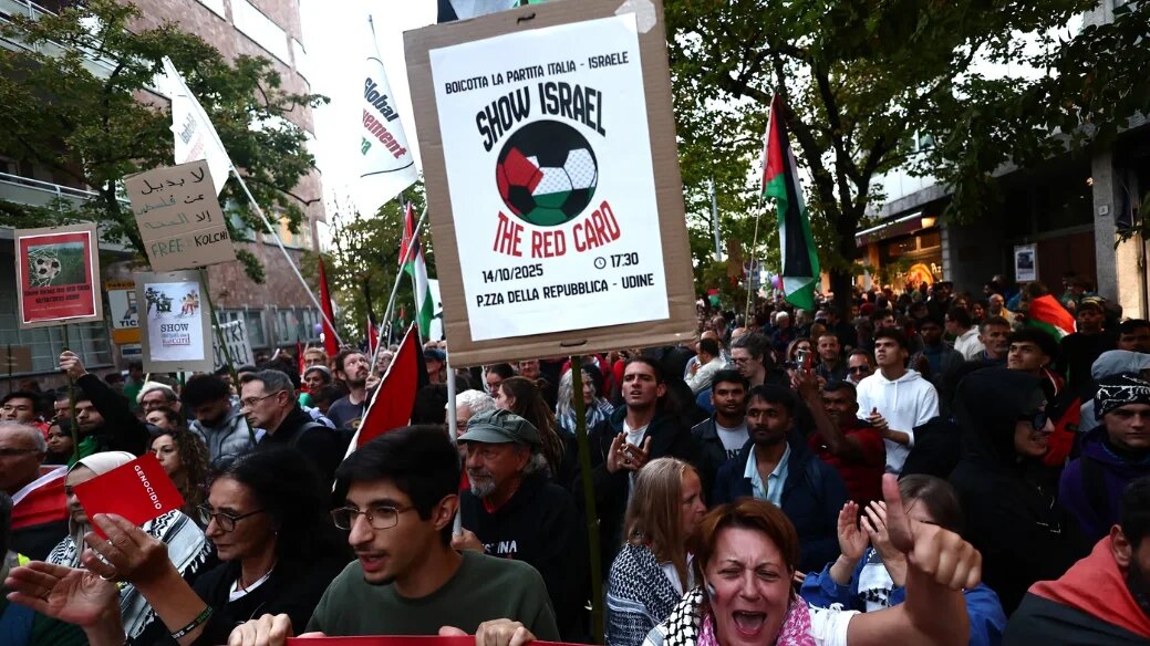 Pro-Palestinian demonstrators march against the Israeli football team ahead of the Italy v Israel Fifa World Cup qualifying match on 14 October 2025 (Yara Nardi/Reuters)