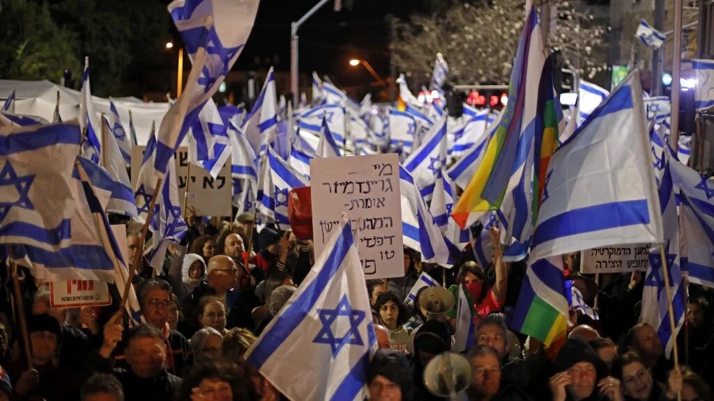 Protesters gather during a rally against the government's controversial judicial overhaul bill in Tel Aviv, Israel, on 18 March 2023 (AFP)