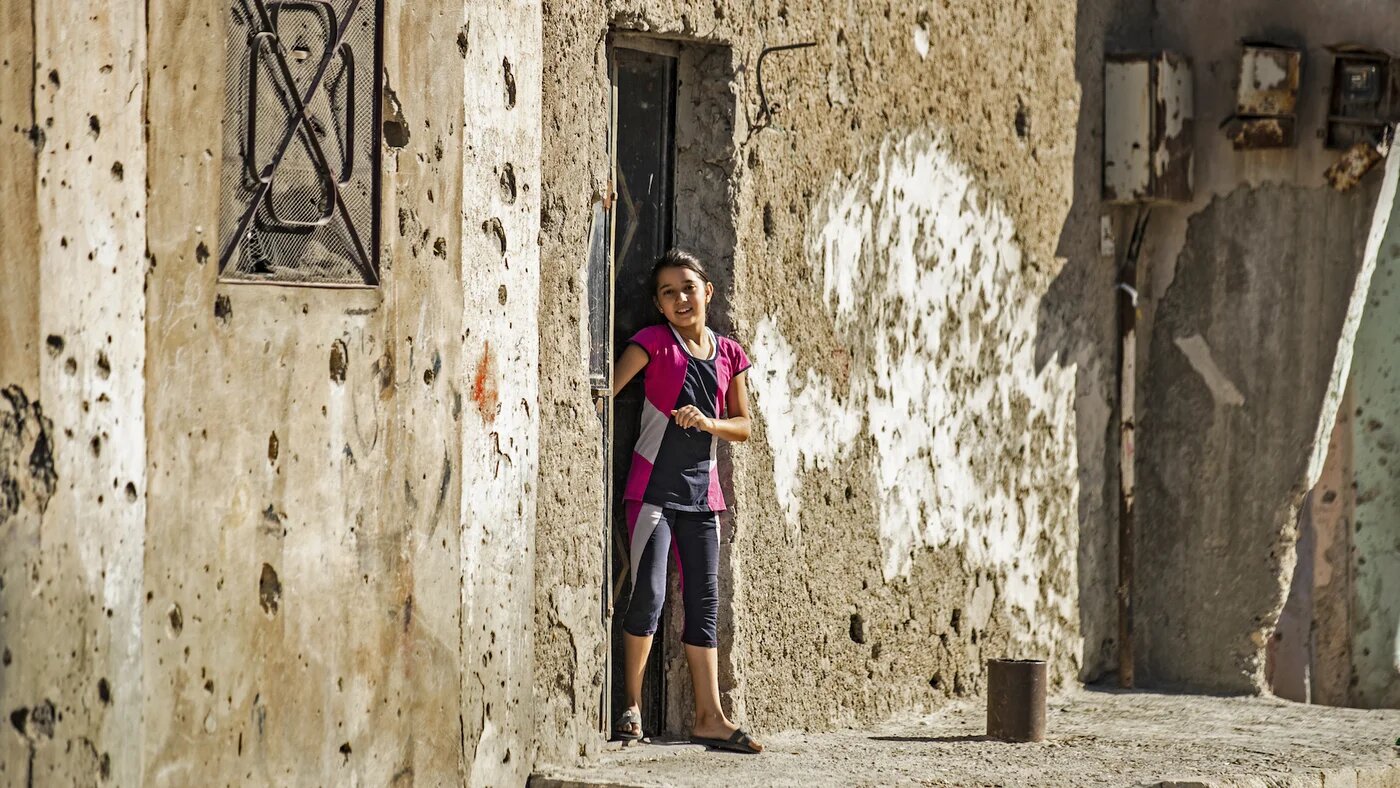 Girl outside house in Raqqa, Syria