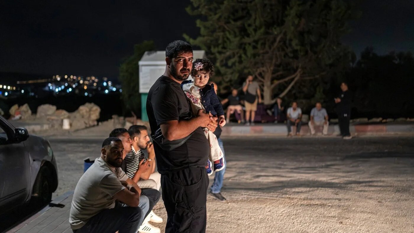 Relatives of Palestinian prisoners await their release near Ramallah in the occupied West Bank, 8 July 2026 (Ilia Yefimovich/AFP)